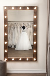 Photo of Beautiful wedding dress on mannequin in boutique