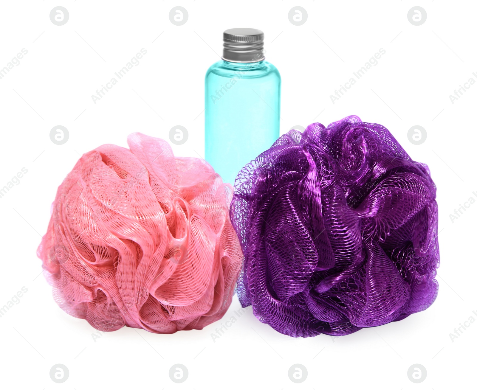 Photo of New shower puffs and bottle of cosmetic product on white background