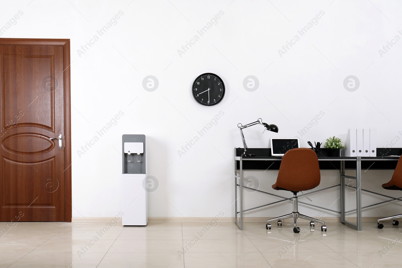 Photo of Modern water cooler in stylish office interior