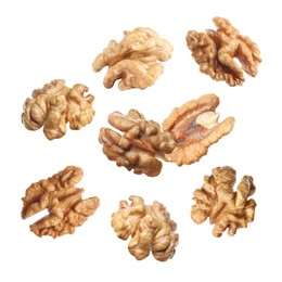 Image of Halves of walnuts falling on white background 