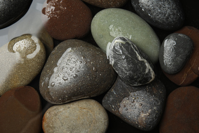 Pile of stones in water as background, top view. Zen lifestyle