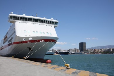 Photo of Modern ferry moored in sea port on sunny day