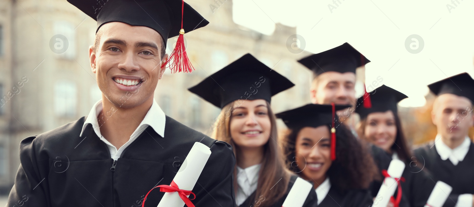 Image of Happy students with diplomas near campus. Banner design