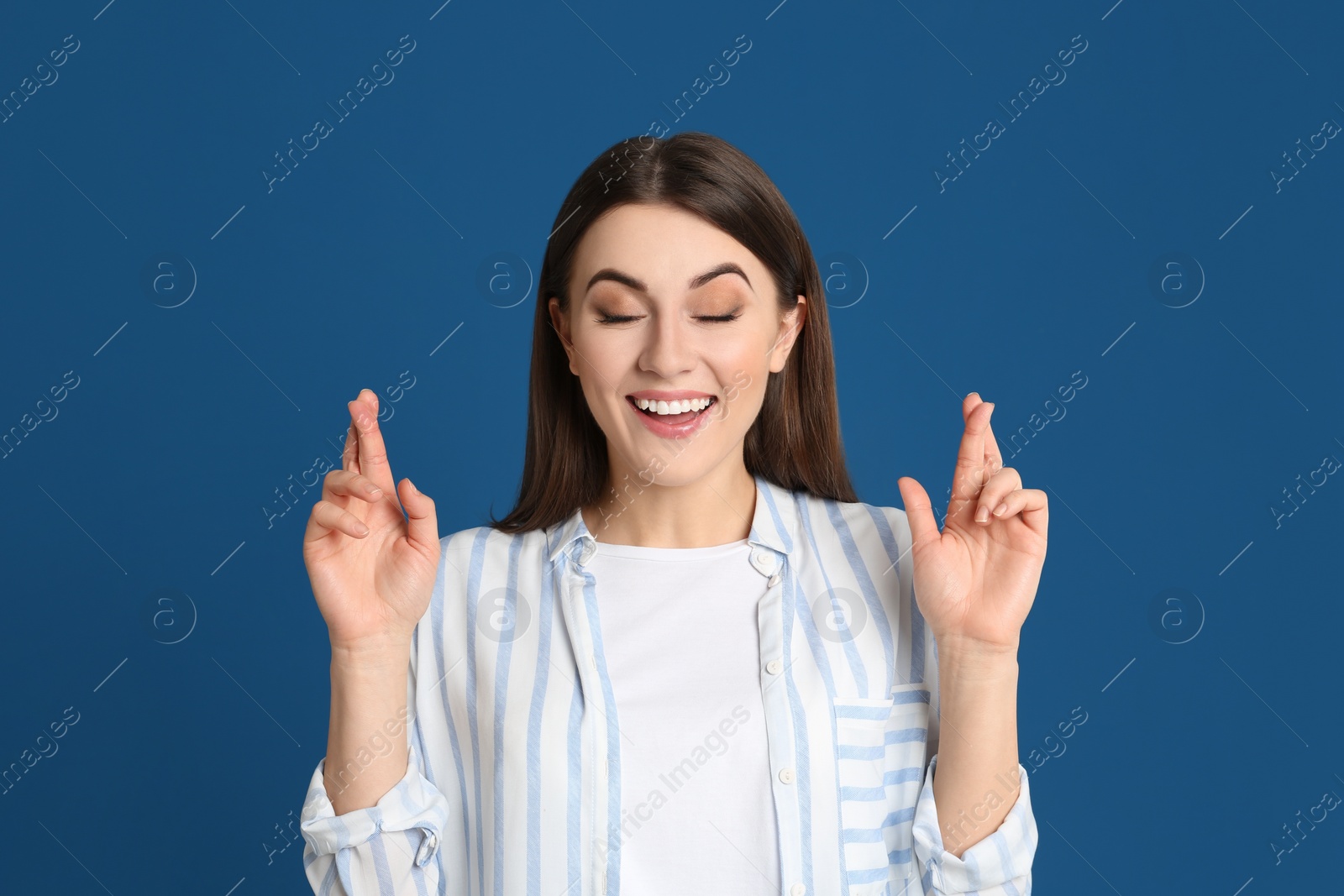 Photo of Portrait of emotional young woman on blue background