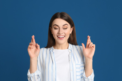 Portrait of emotional young woman on blue background