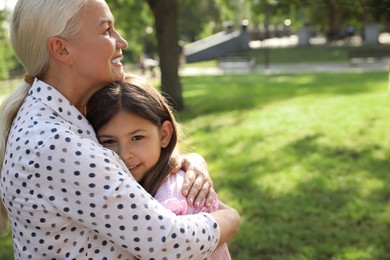 Mature woman with her little granddaughter in park