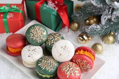 Beautifully decorated Christmas macarons, gift boxes and festive decor on snow