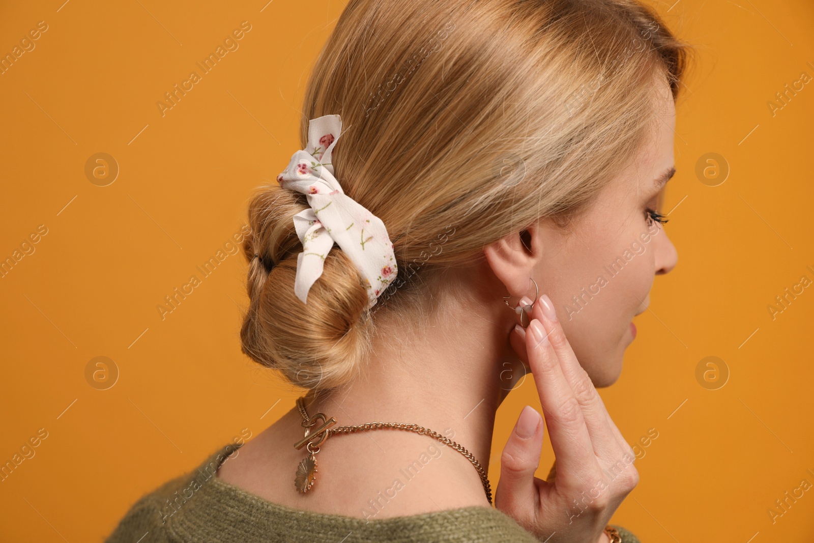 Photo of Young woman with stylish bandana on yellow background