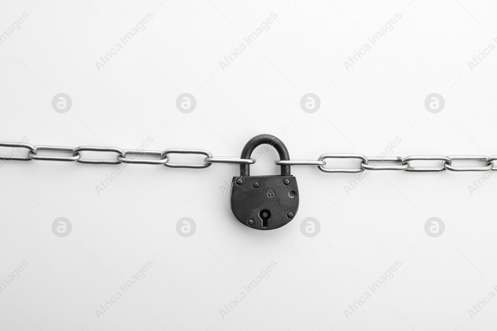 Photo of Steel padlock and chain isolated on white, top view. Safety concept