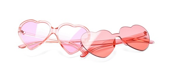 Different stylish heart shaped glasses on white background