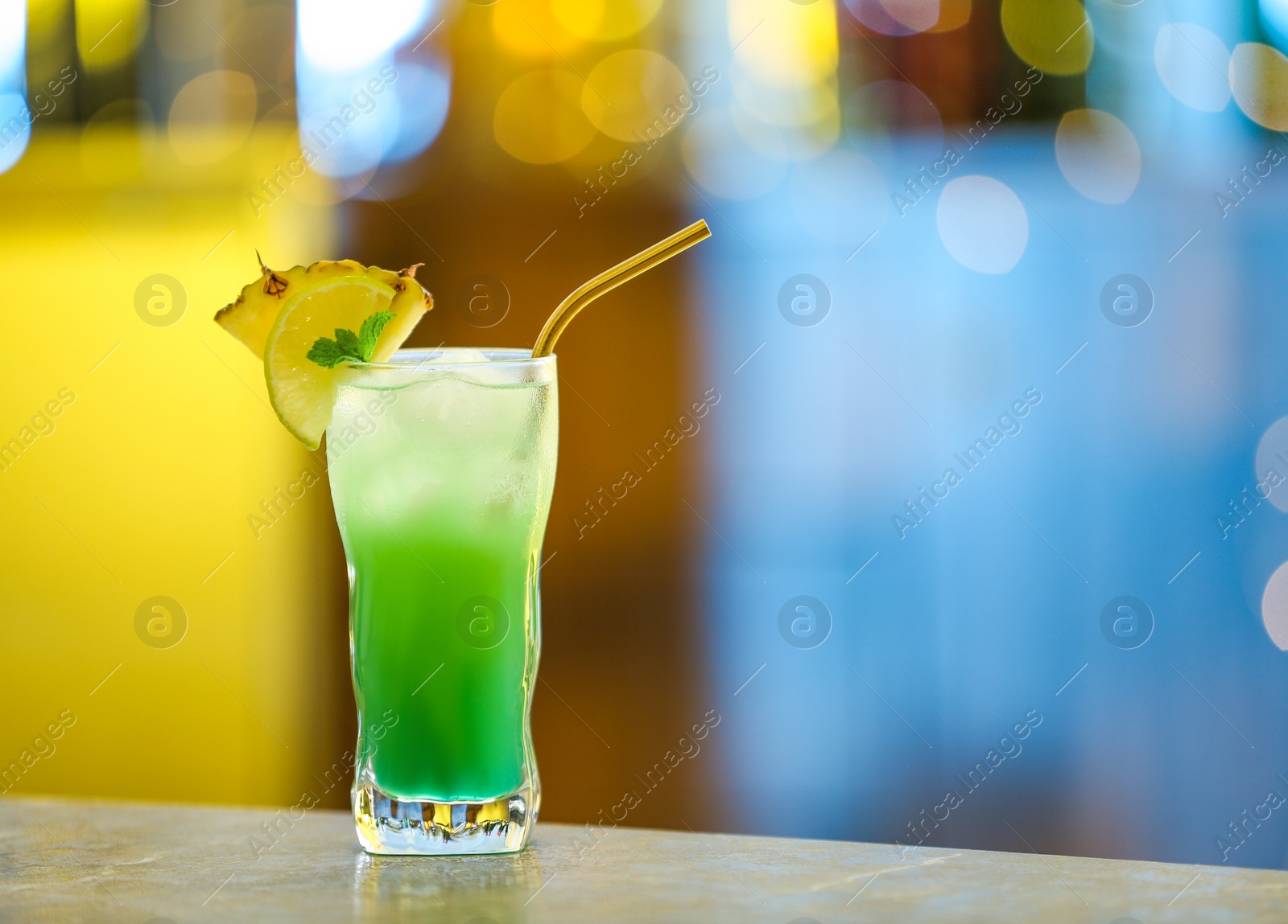Photo of Fresh alcoholic cocktail with pineapple and lemon on bar counter, space for text