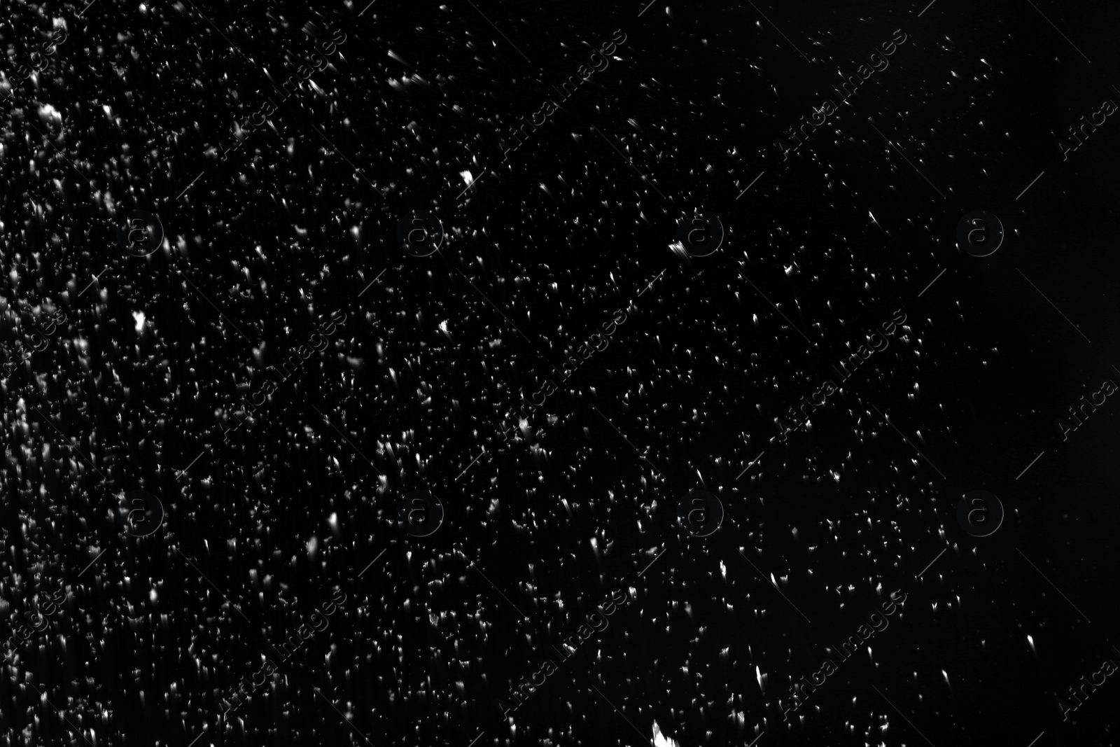 Photo of Snow flakes falling on black background. Winter weather