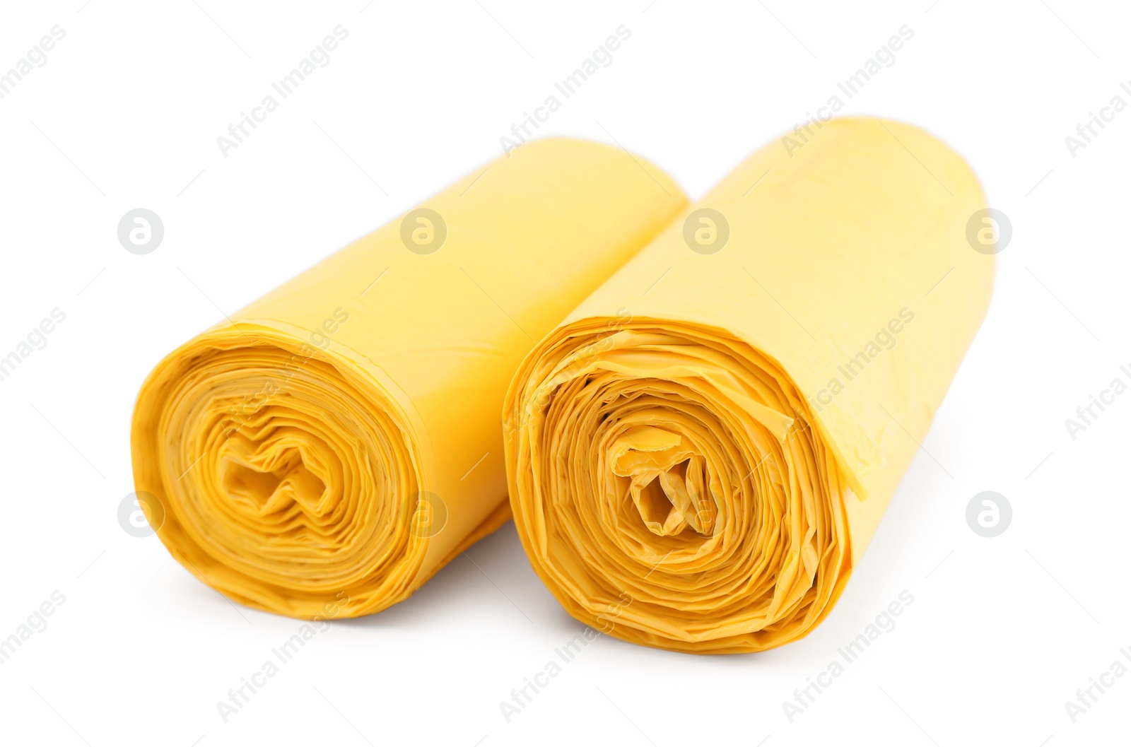 Photo of Two rolls of yellow garbage bags isolated on white