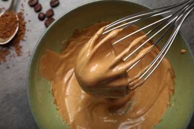 Photo of Whipping coffee cream at gray table, top view