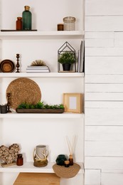 Photo of Wall shelves with beautiful decor elements indoors. Interior design