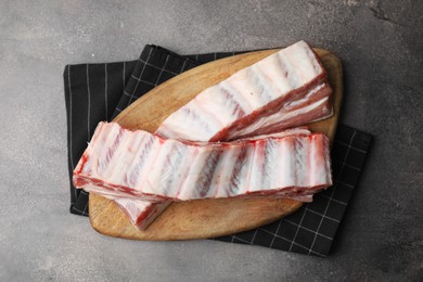 Photo of Raw pork ribs on grey table, top view