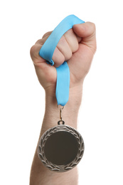 Photo of Man holding silver medal on white background, closeup. Space for design