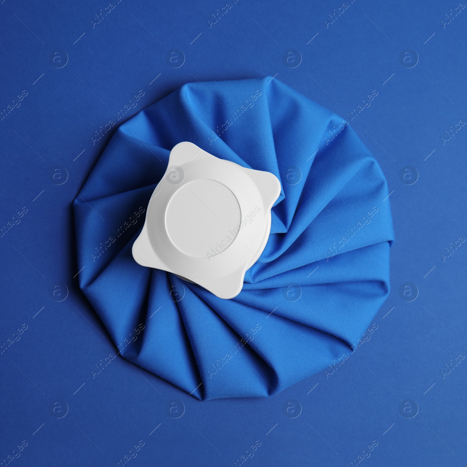 Photo of Ice pack on blue background, top view