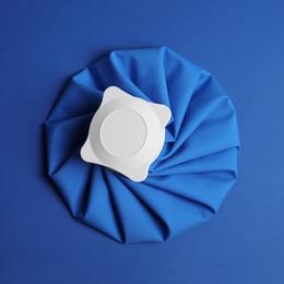 Photo of Ice pack on blue background, top view