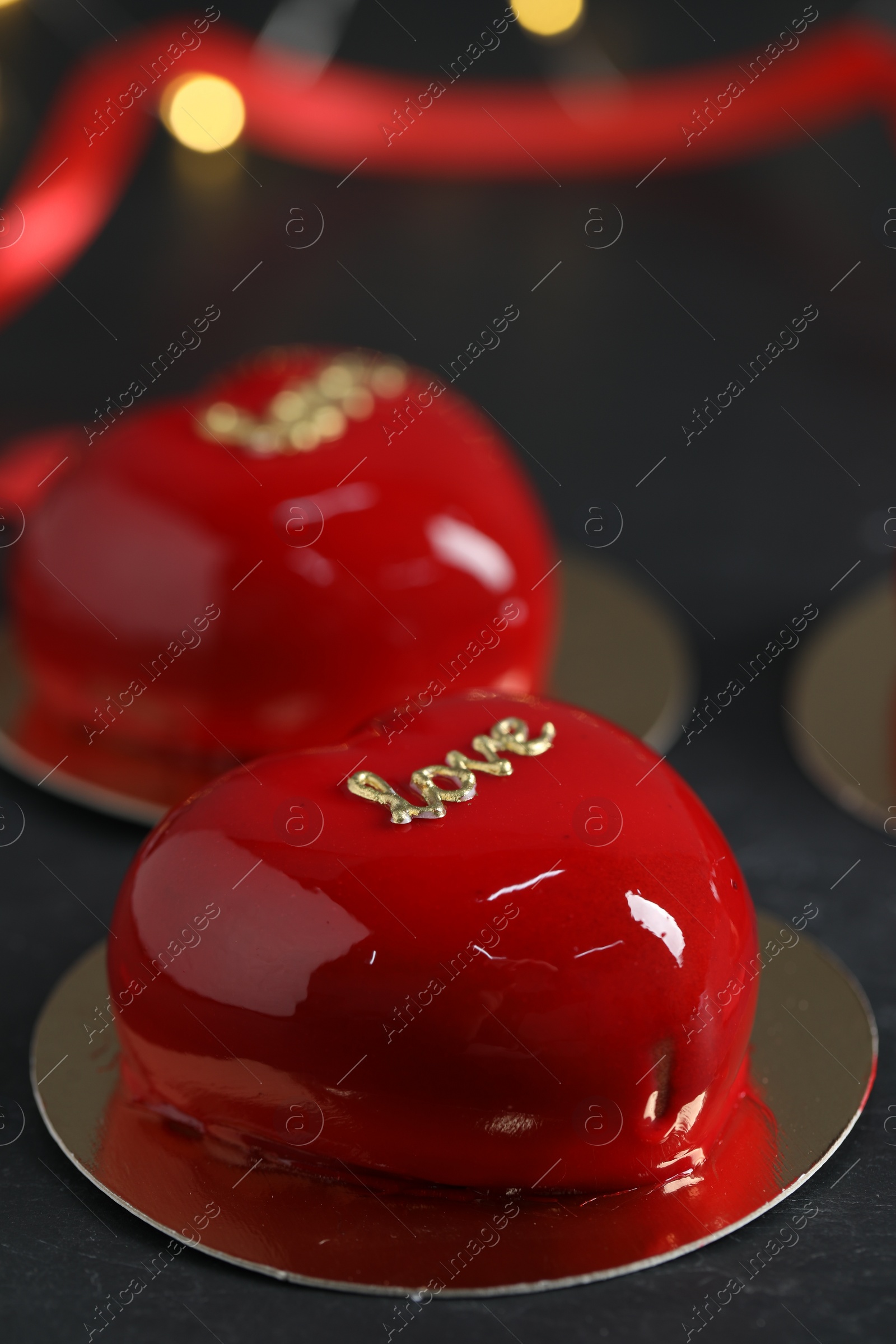 Photo of St. Valentine's Day. Delicious heart shaped cakes on black table, closeup