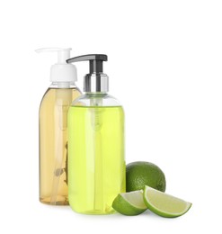 Photo of Dispensers with liquid soap and limes on white background