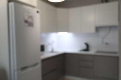 Photo of Blurred view of stylish modern kitchen interior