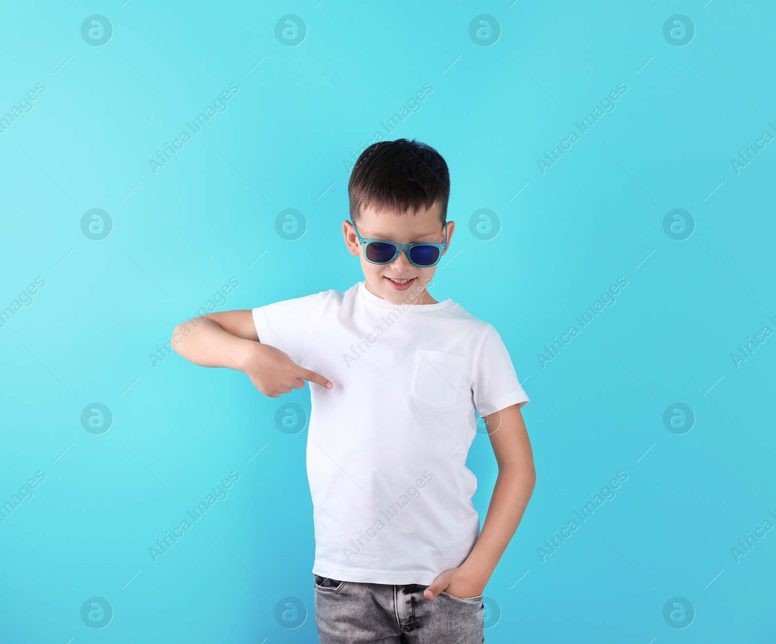 Photo of Little boy in t-shirt on color background. Mock-up for design