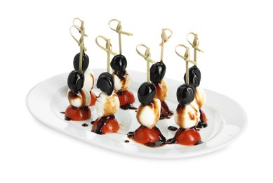 Photo of Tasty canapes with black olives, mozzarella and cherry tomatoes isolated on white