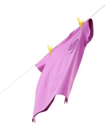 Photo of One violet t-shirt drying on washing line isolated on white