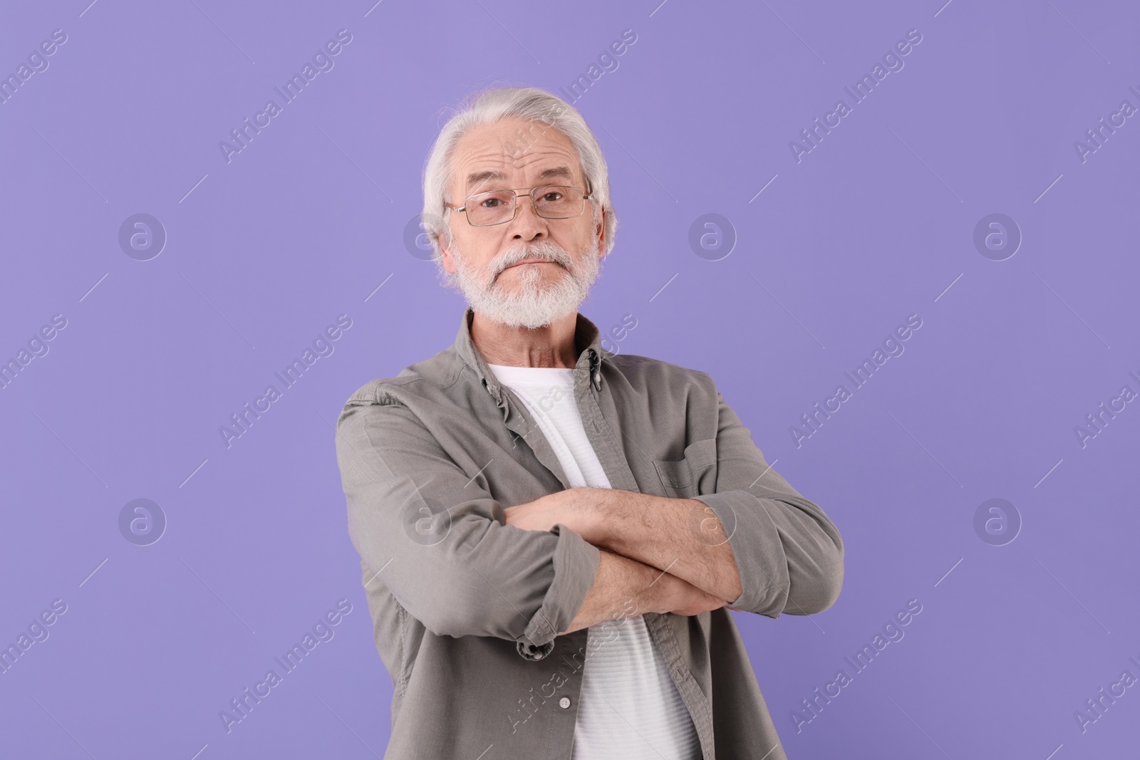 Photo of Portrait of stylish grandpa with glasses on purple background