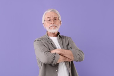Photo of Portrait of stylish grandpa with glasses on purple background