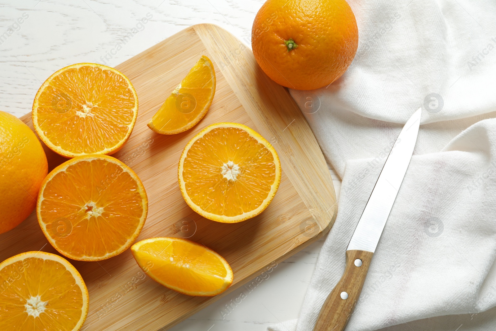 Photo of Flat lay composition with ripe oranges, cutting board and knife on table