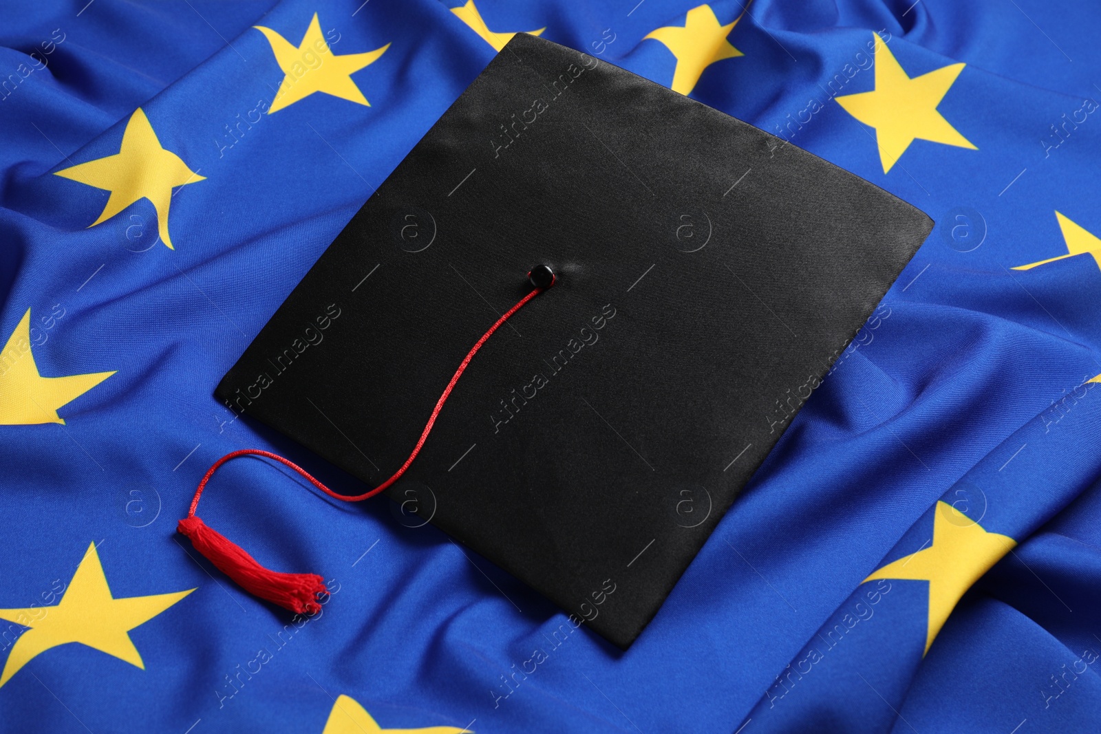 Photo of Black graduation cap on flag of European Union