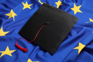 Black graduation cap on flag of European Union