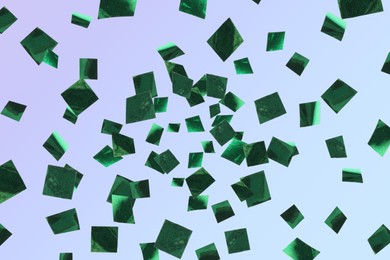 Image of Shiny green confetti falling on light blue background