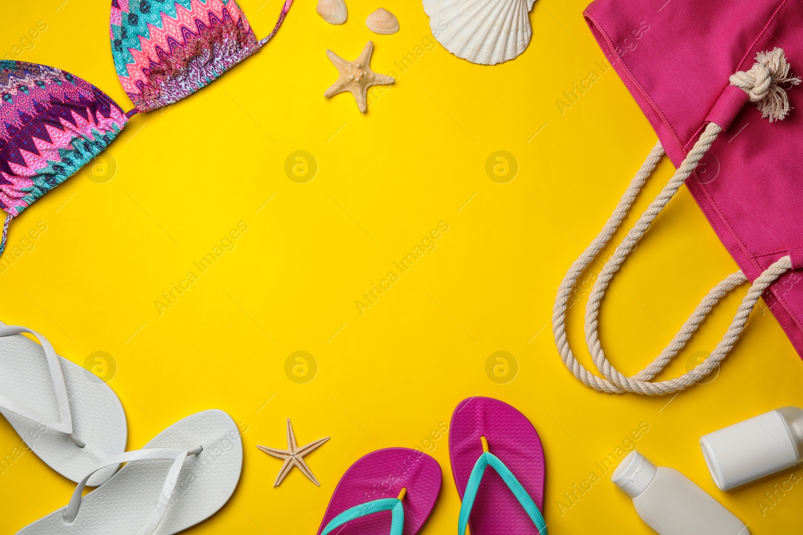 Photo of Flat lay composition with beach accessories on color background. Space for text