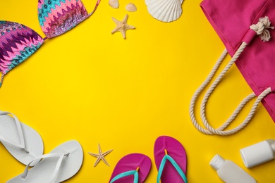 Flat lay composition with beach accessories on color background. Space for text