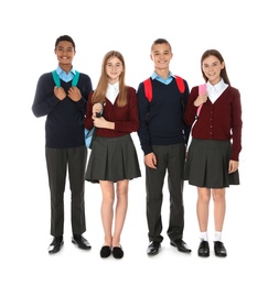 Photo of Full length portrait of teenagers in school uniform with backpacks on white background