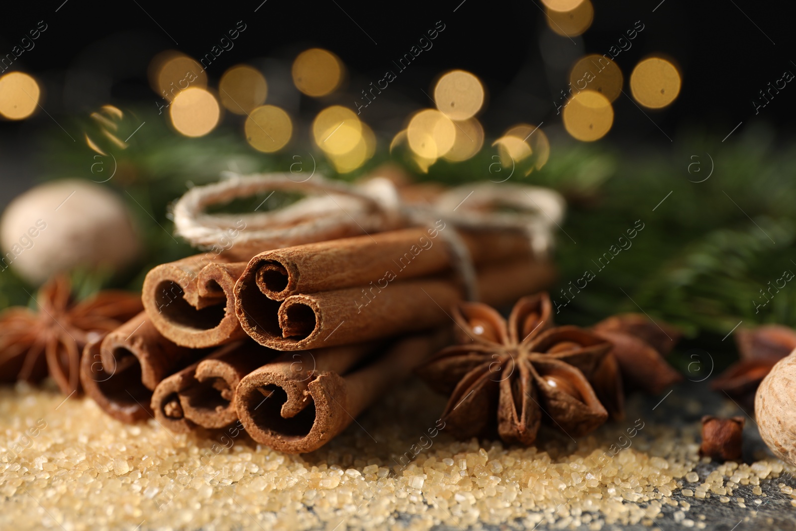 Photo of Different spices on table against blurred lights, closeup