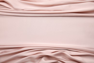 Texture of delicate pink silk as background, top view