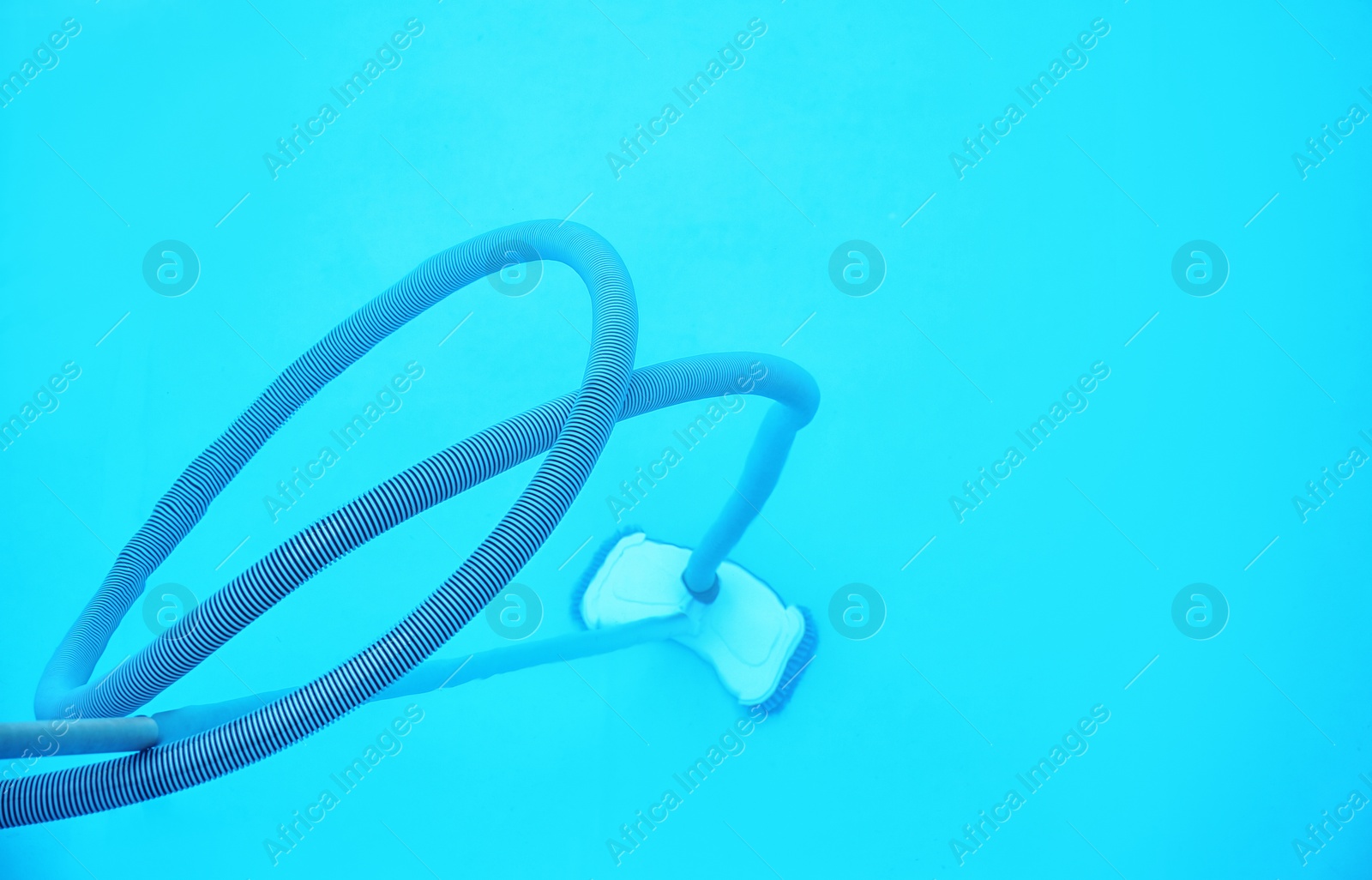 Photo of Cleaning outdoor pool with underwater vacuum, closeup