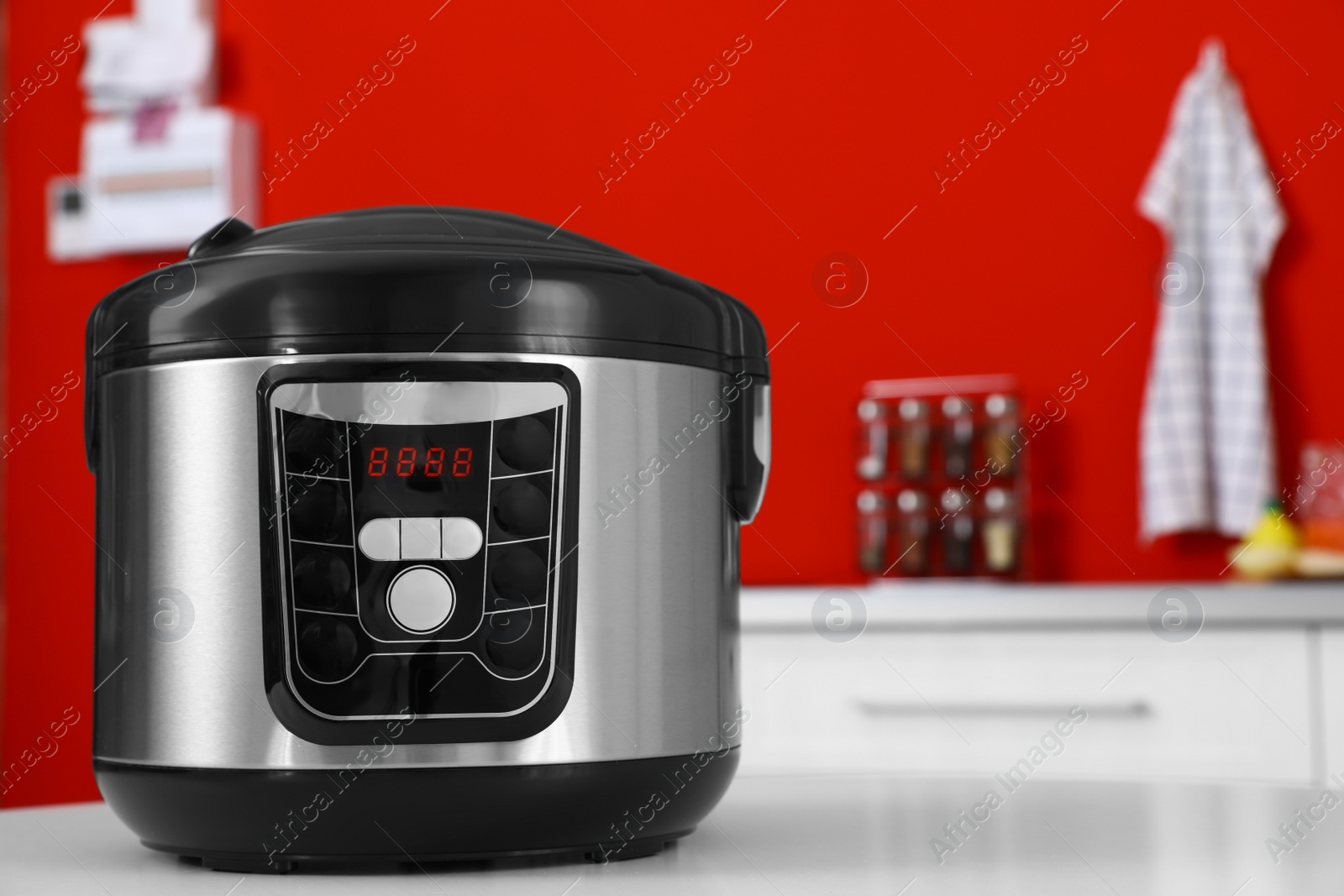 Photo of New modern multi cooker on table in kitchen. Space for text