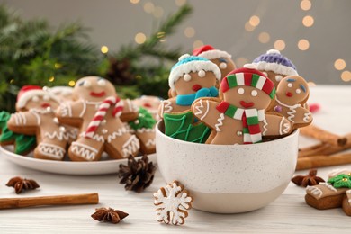 Photo of Delicious homemade Christmas cookies on white wooden table against blurred festive lights
