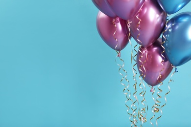 Photo of Bright balloons on color background. Space for text