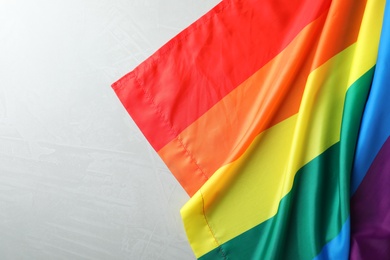 Photo of Rainbow gay flag on grey background, top view with space for text. LGBT concept