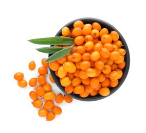 Photo of Bowl with fresh ripe sea buckthorn berries and green leaves on white background, top view