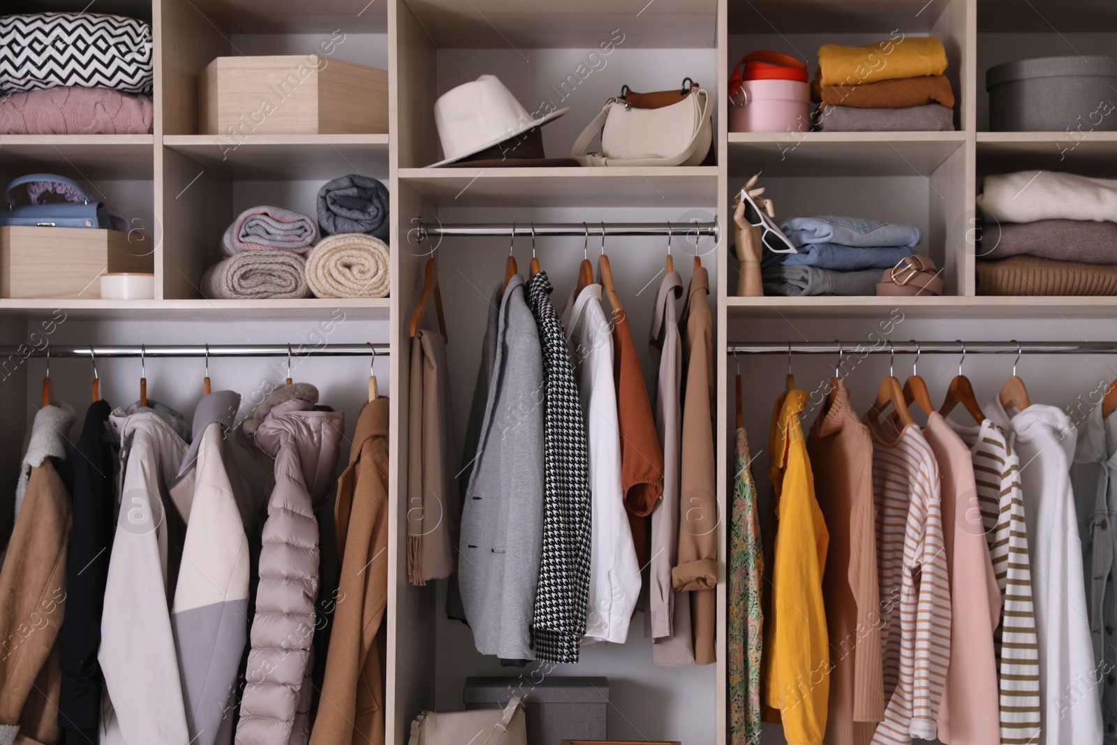 Photo of Wardrobe closet with different stylish clothes, accessories and home stuff