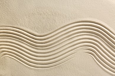 Photo of Beautiful lines on sand, top view. Zen garden
