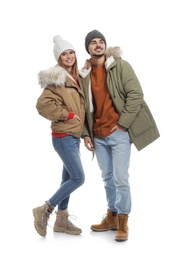 Photo of Young couple wearing warm clothes on white background. Ready for winter vacation