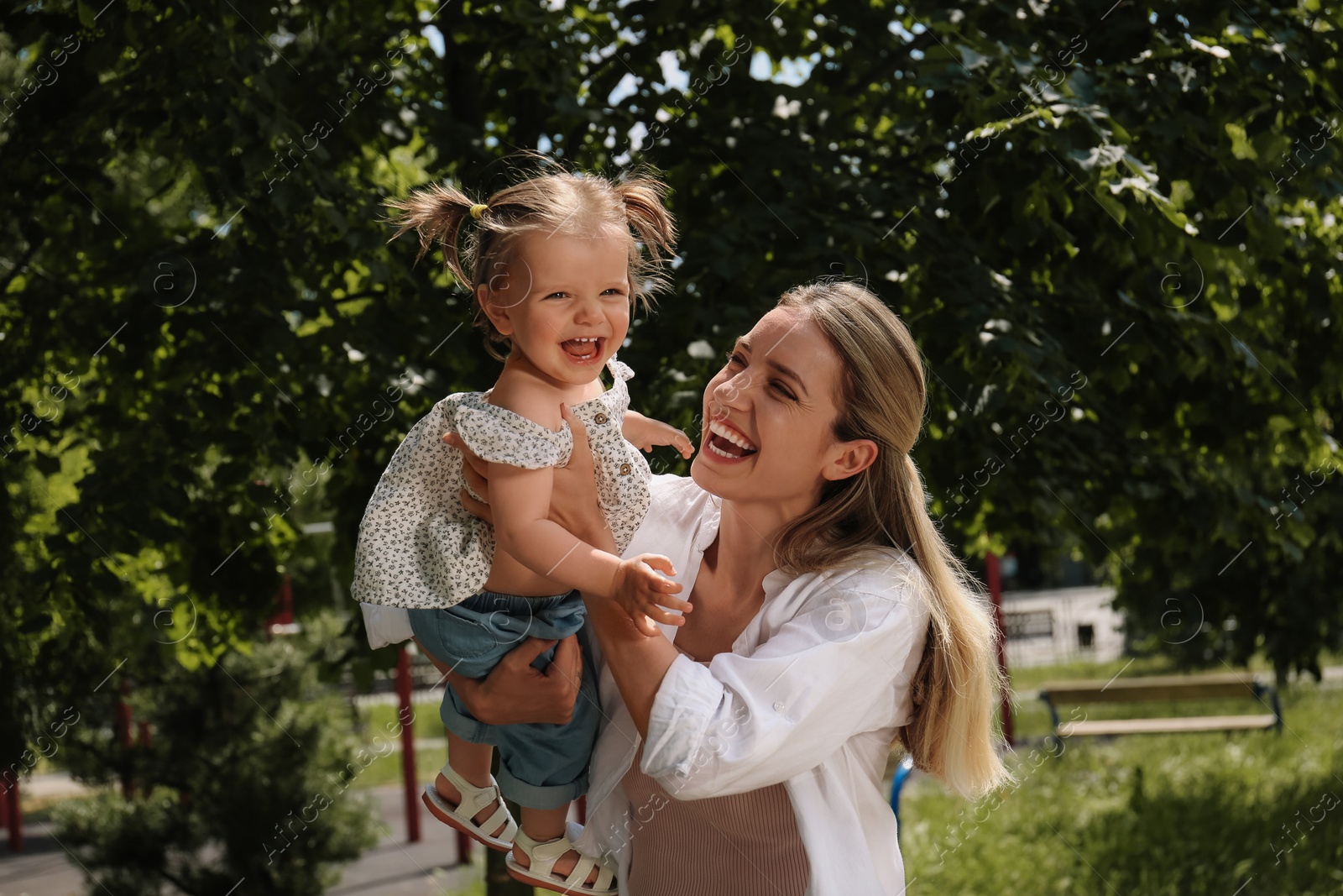 Photo of Happy mother with her daughter having fun in park